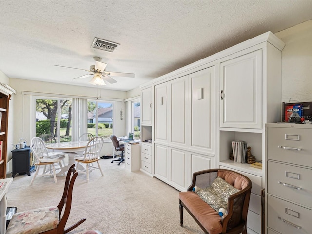 11536 Golden Rain Dr, New Port Richey, FL 34654 - office area with ceiling fan, light colored carpet, and a textured ceiling