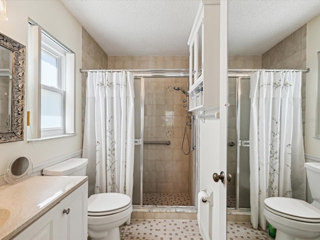 11536 Golden Rain Dr, New Port Richey, FL 34654 - bathroom featuring toilet, a shower stall, vanity, and a textured ceiling