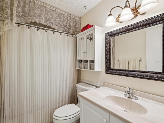 11536 Golden Rain Dr, New Port Richey, FL 34654 - bathroom featuring toilet, vanity, a textured ceiling, and a shower with curtain
