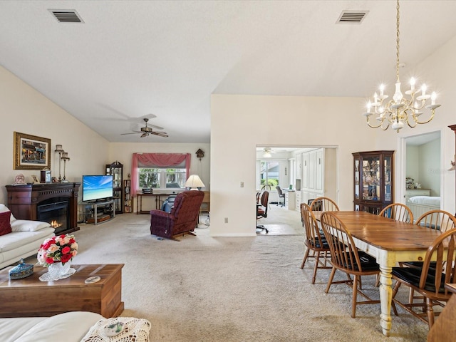 11536 Golden Rain Dr, New Port Richey, FL 34654 - carpeted dining space featuring lofted ceiling, a glass covered fireplace, a chandelier, and ceiling fan