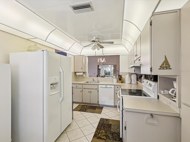 11536 Golden Rain Dr, New Port Richey, FL 34654 - kitchen with white appliances, a sink, light countertops, and light tile patterned floors
