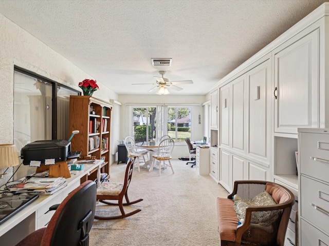 11536 Golden Rain Dr, New Port Richey, FL 34654 - office area with light carpet, a ceiling fan, and a textured ceiling