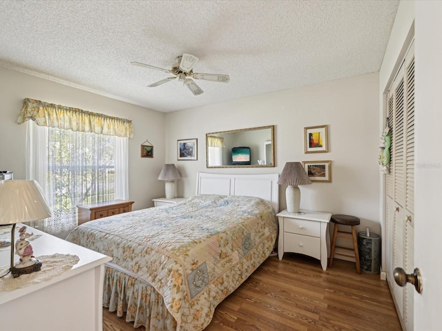 11536 Golden Rain Dr, New Port Richey, FL 34654 - bedroom with a textured ceiling, dark wood-style floors, a ceiling fan, and a closet