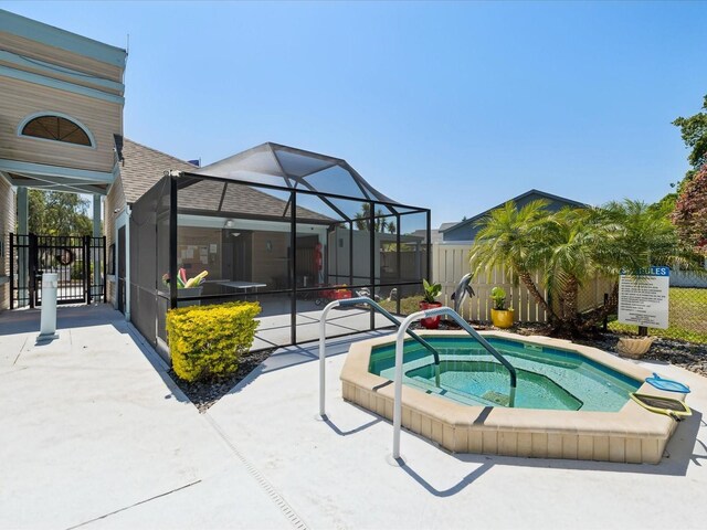 11536 Golden Rain Dr, New Port Richey, FL 34654 - view of pool featuring a hot tub, fence, glass enclosure, and a patio