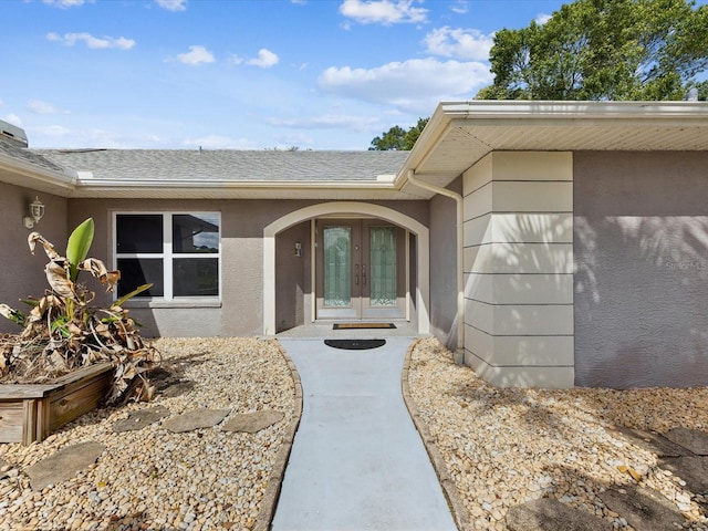 5411 Joyner Ave, Spring Hill, FL 34608 - doorway to property featuring stucco siding, roof with shingles, and french doors