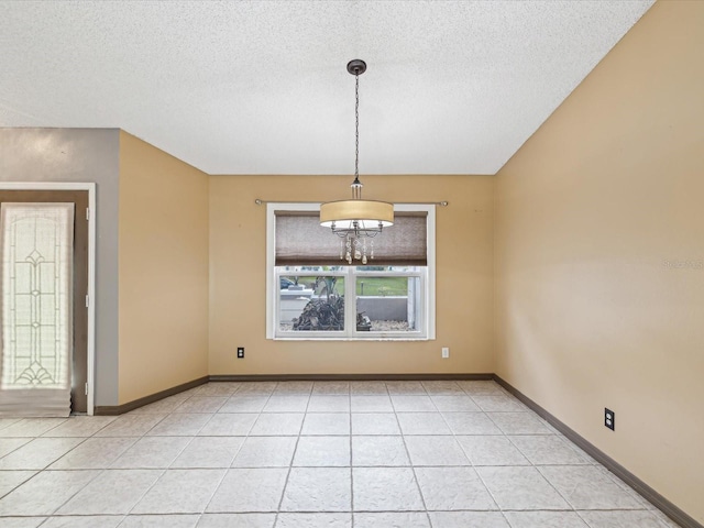 5411 Joyner Ave, Spring Hill, FL 34608 - unfurnished dining area featuring baseboards, an inviting chandelier, a textured ceiling, and light tile patterned floors