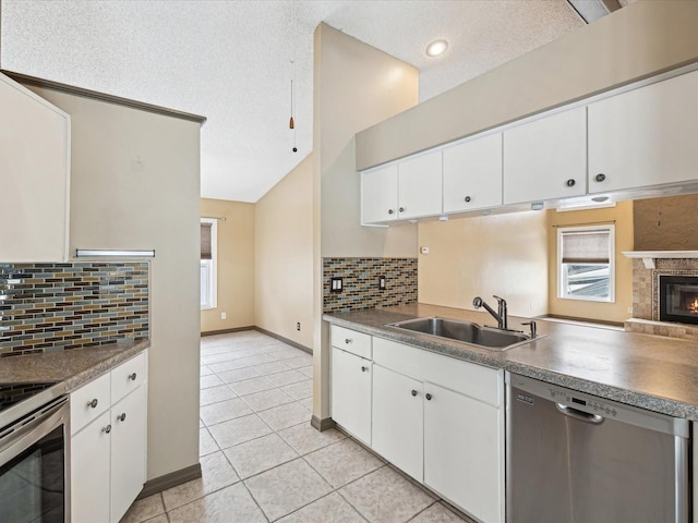 5411 Joyner Ave, Spring Hill, FL 34608 - kitchen featuring a textured ceiling, a sink, tasteful backsplash, light tile patterned flooring, and appliances with stainless steel finishes