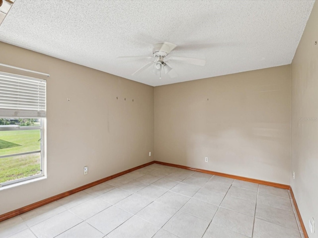 5411 Joyner Ave, Spring Hill, FL 34608 - unfurnished room with a textured ceiling, a ceiling fan, baseboards, and light tile patterned floors