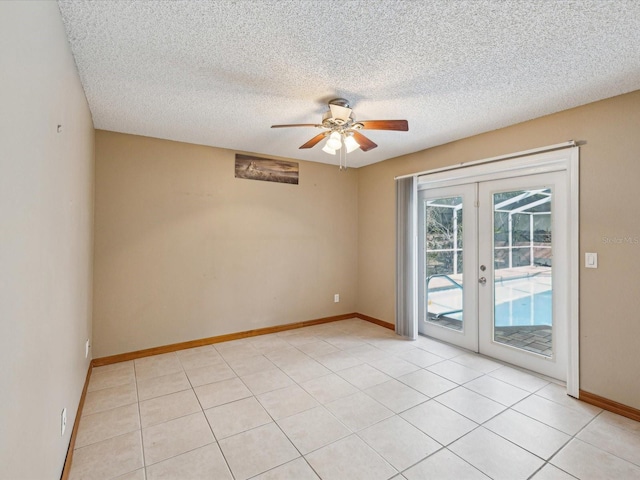 5411 Joyner Ave, Spring Hill, FL 34608 - unfurnished room featuring a textured ceiling, light tile patterned floors, ceiling fan, french doors, and baseboards