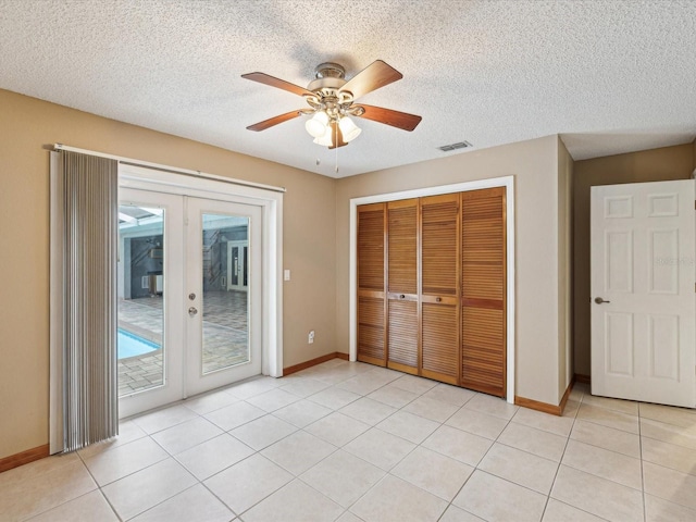 5411 Joyner Ave, Spring Hill, FL 34608 - unfurnished bedroom with visible vents, access to exterior, french doors, a closet, and baseboards