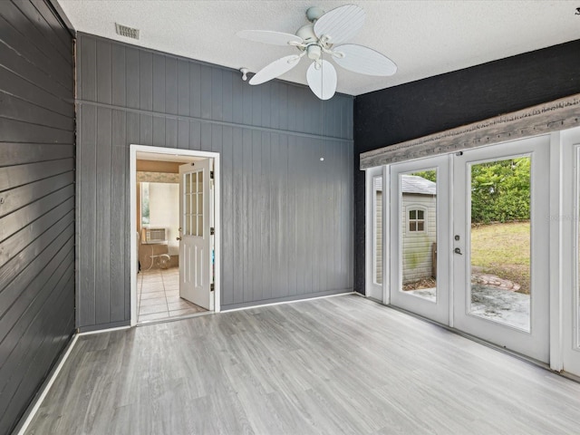 5411 Joyner Ave, Spring Hill, FL 34608 - interior space with wooden walls, wood finished floors, visible vents, and french doors