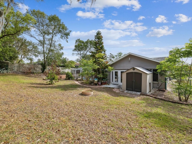 5411 Joyner Ave, Spring Hill, FL 34608 - rear view of house featuring a lawn, an outdoor structure, fence, and a shed
