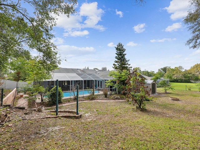 5411 Joyner Ave, Spring Hill, FL 34608 - back of house with an outdoor structure, a shed, an outdoor pool, and fence