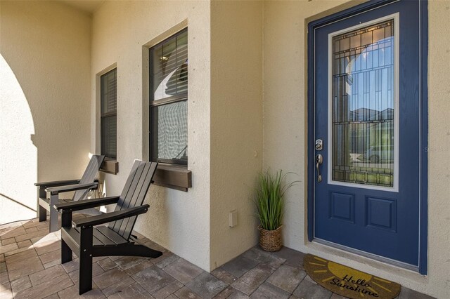 5070 Night Star Trl, Odessa, FL 33556 - doorway to property with stucco siding