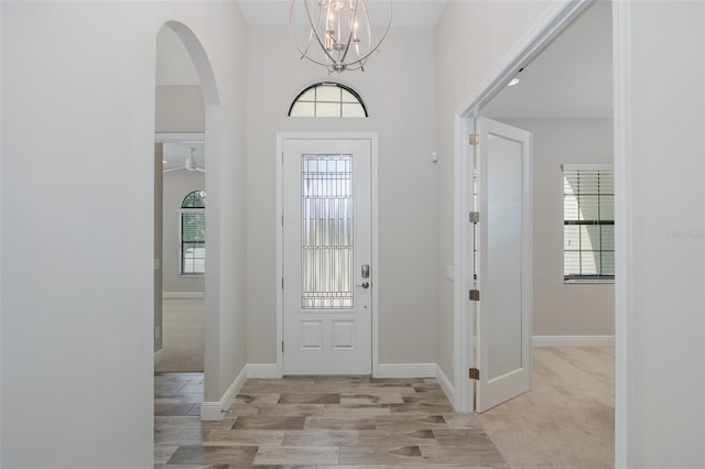 5070 Night Star Trl, Odessa, FL 33556 - entryway featuring a chandelier, baseboards, and arched walkways
