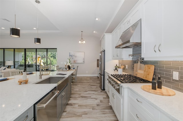 5070 Night Star Trl, Odessa, FL 33556 - kitchen featuring under cabinet range hood, stainless steel appliances, white cabinets, tasteful backsplash, and light stone counters