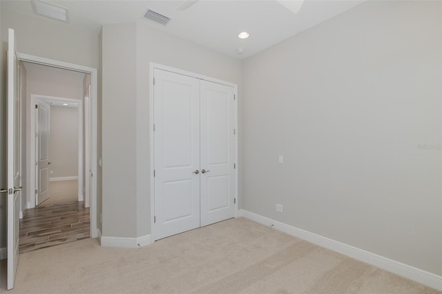 5070 Night Star Trl, Odessa, FL 33556 - unfurnished bedroom featuring light carpet, a closet, baseboards, and recessed lighting