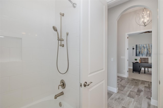 5070 Night Star Trl, Odessa, FL 33556 - bathroom featuring bathtub / shower combination and a chandelier
