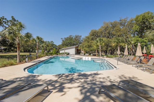 5070 Night Star Trl, Odessa, FL 33556 - community pool featuring a patio area and view of wooded area