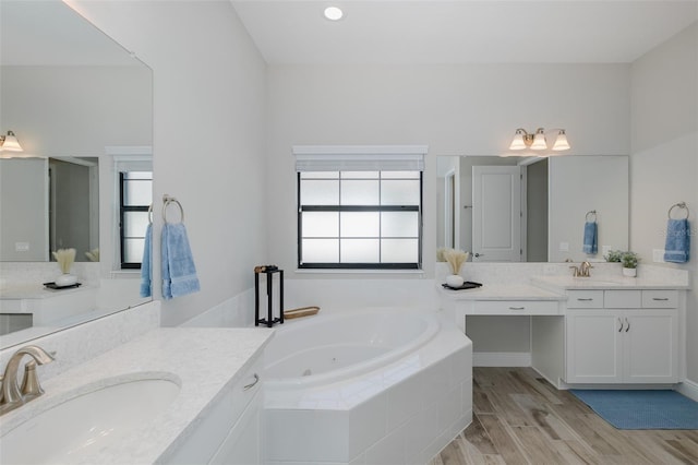 5070 Night Star Trl, Odessa, FL 33556 - full bath featuring a whirlpool tub, two vanities, and wood finished floors