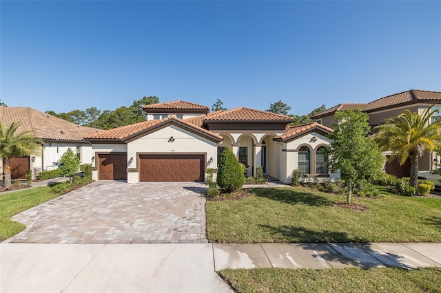 5070 Night Star Trl, Odessa, FL 33556 - mediterranean / spanish-style house with stucco siding, an attached garage, a front yard, decorative driveway, and a tile roof