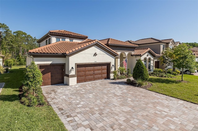 5070 Night Star Trl, Odessa, FL 33556 - mediterranean / spanish home with stucco siding, an attached garage, a front yard, decorative driveway, and a tile roof