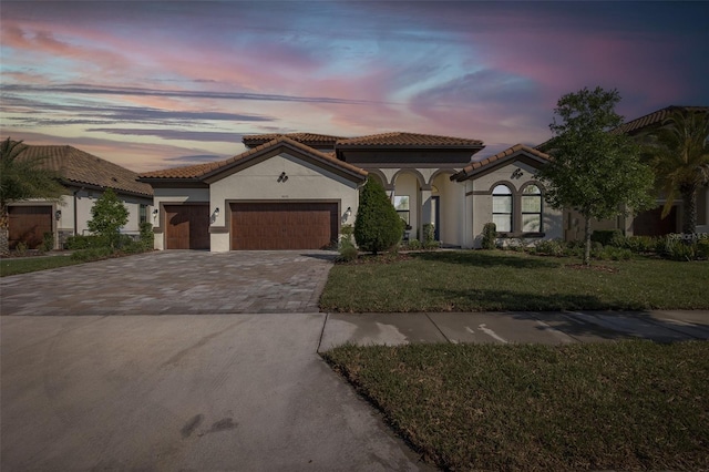 5070 Night Star Trl, Odessa, FL 33556 - mediterranean / spanish home with stucco siding, a garage, driveway, a front yard, and a tile roof