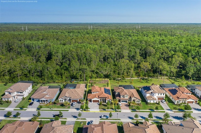 5070 Night Star Trl, Odessa, FL 33556 - aerial view of property and surrounding area featuring a forest, property parcel outlined, and nearby suburban area