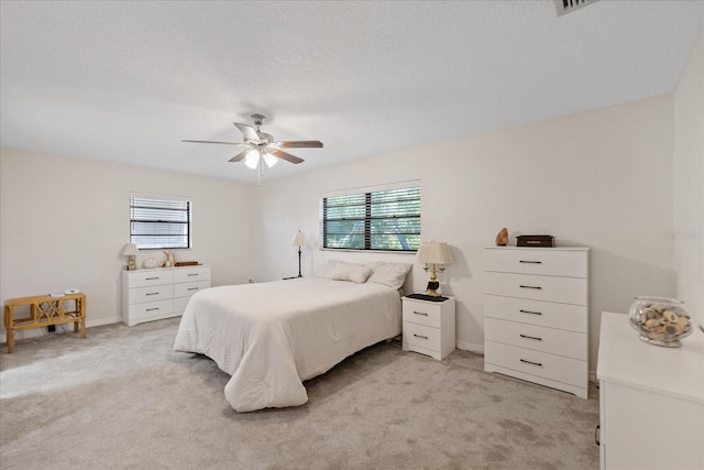 4504 Dewey Dr, New Port Richey, FL 34652 - bedroom with multiple windows, light carpet, and a ceiling fan