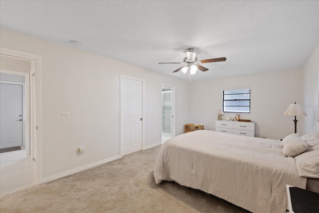4504 Dewey Dr, New Port Richey, FL 34652 - bedroom with light carpet, a ceiling fan, connected bathroom, and a textured ceiling