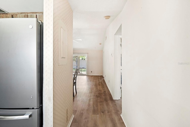 hall with baseboards, wood finished floors, and wallpapered walls
