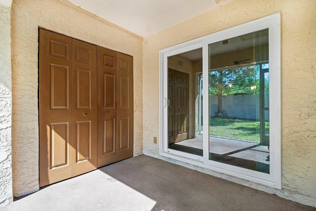 property entrance with stucco siding
