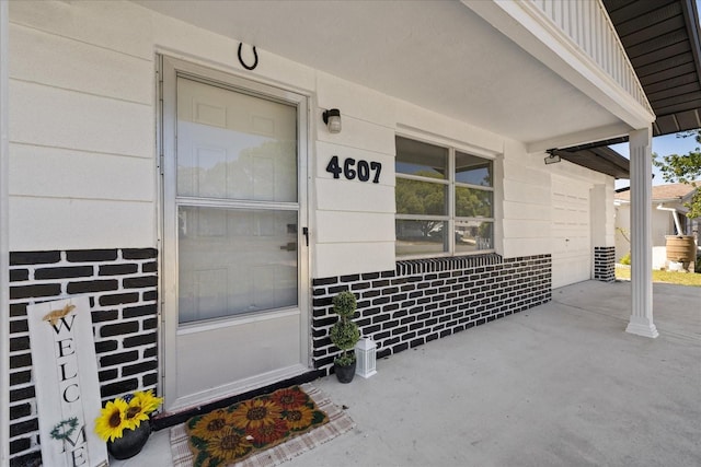 4607 Kennedy Dr, New Port Richey, FL 34652 - doorway to property featuring board and batten siding and covered porch