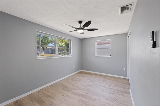 4607 Kennedy Dr, New Port Richey, FL 34652 - spare room featuring light wood-style flooring, visible vents, a ceiling fan, and baseboards