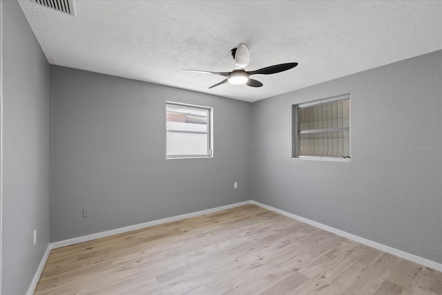 4607 Kennedy Dr, New Port Richey, FL 34652 - spare room featuring wood finished floors, visible vents, a textured ceiling, and ceiling fan