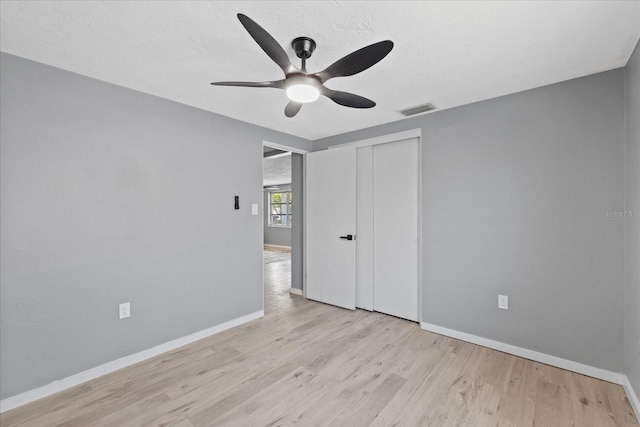 4607 Kennedy Dr, New Port Richey, FL 34652 - unfurnished bedroom featuring a closet, light wood-style flooring, visible vents, and baseboards