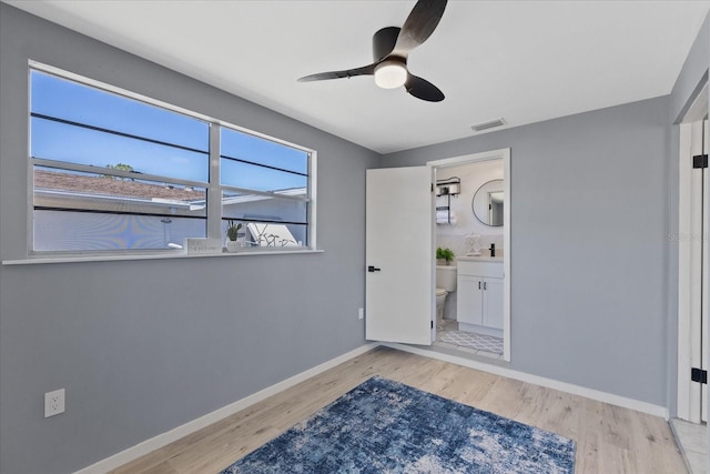 4607 Kennedy Dr, New Port Richey, FL 34652 - interior space featuring wood finished floors, visible vents, a ceiling fan, and baseboards