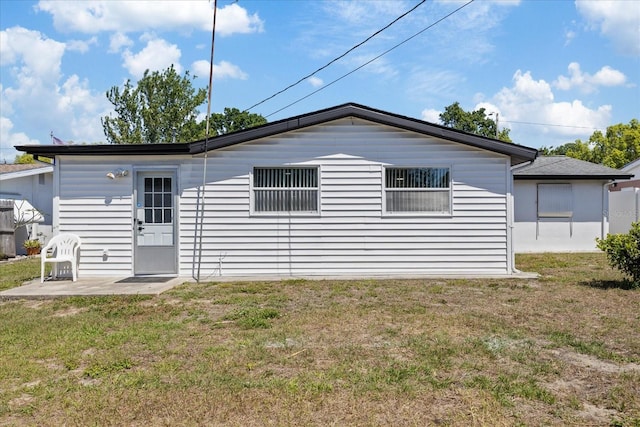 4607 Kennedy Dr, New Port Richey, FL 34652 - rear view of property featuring a patio area and a yard