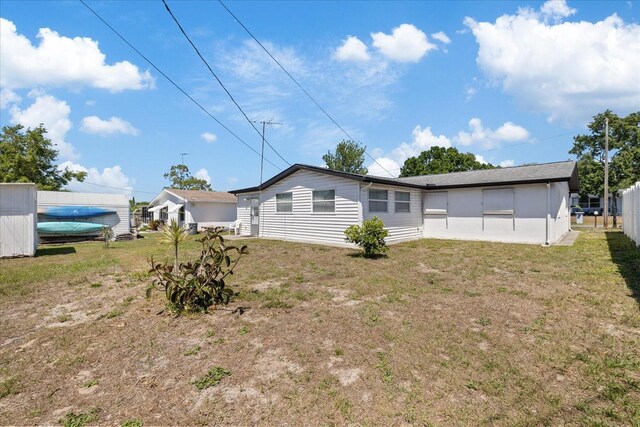 4607 Kennedy Dr, New Port Richey, FL 34652 - rear view of house with a lawn