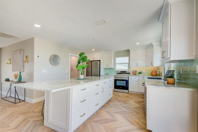 6432 Boatyard Dr, Hudson, FL 34667 - kitchen featuring appliances with stainless steel finishes, visible vents, recessed lighting, and a sink