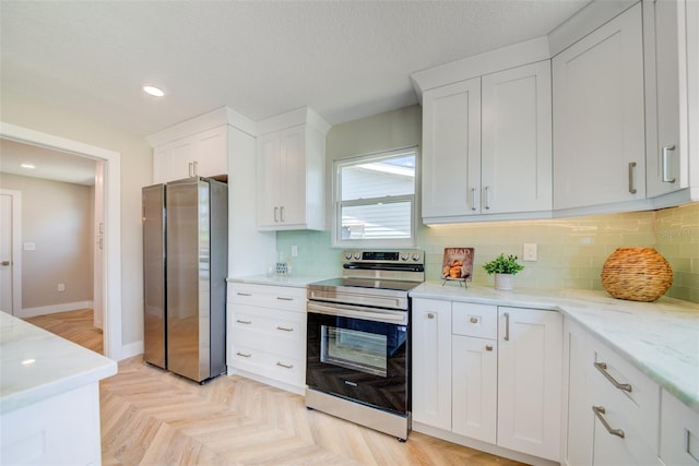 6432 Boatyard Dr, Hudson, FL 34667 - kitchen with white cabinetry, baseboards, stainless steel appliances, and backsplash