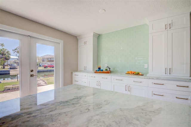 6432 Boatyard Dr, Hudson, FL 34667 - mudroom featuring a textured ceiling and french doors