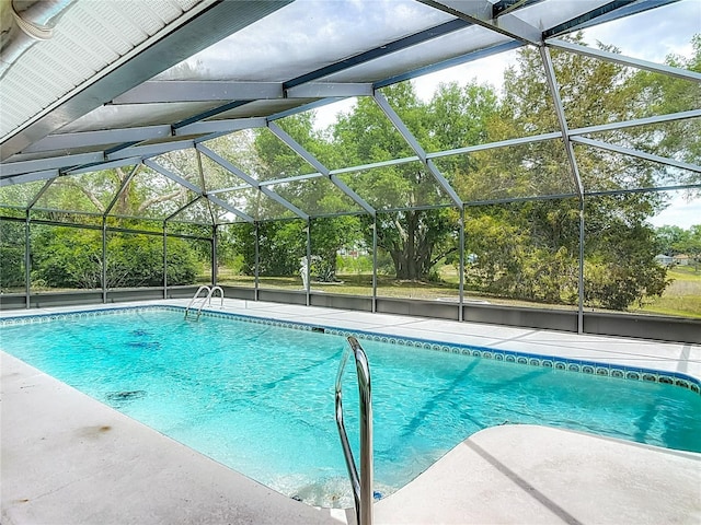 outdoor pool with a patio area and a lanai