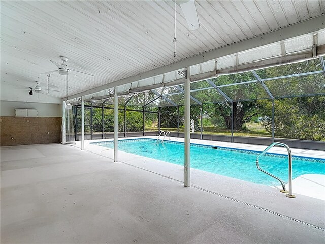 outdoor pool with a patio area, a lanai, and a ceiling fan