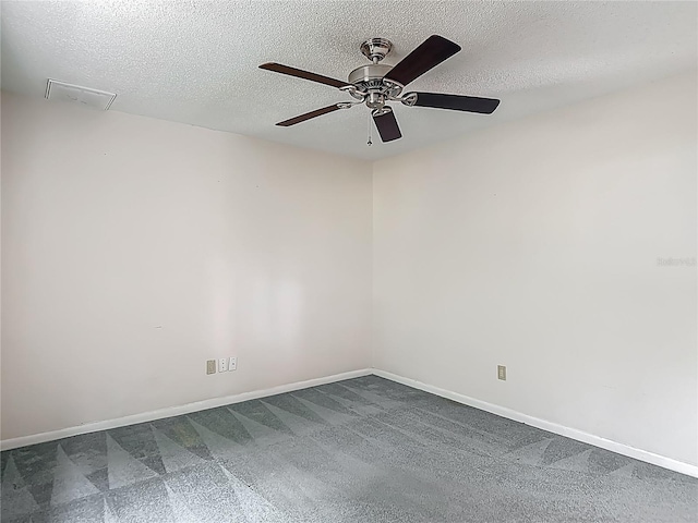 empty room with baseboards, a ceiling fan, a textured ceiling, and visible vents