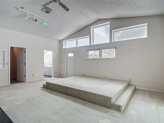 unfurnished bedroom featuring carpet floors, a textured ceiling, and visible vents