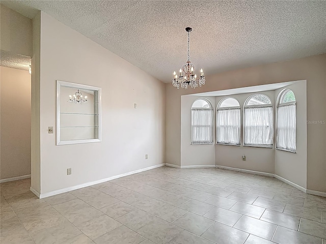 tiled spare room with an inviting chandelier, a textured ceiling, and baseboards