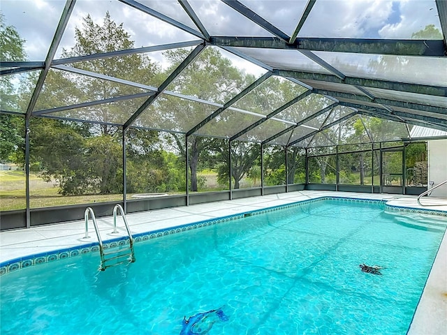 outdoor pool with a lanai and a patio area