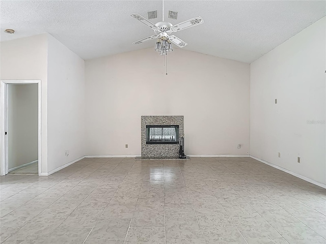 unfurnished living room featuring vaulted ceiling, a ceiling fan, baseboards, a fireplace, and a textured ceiling