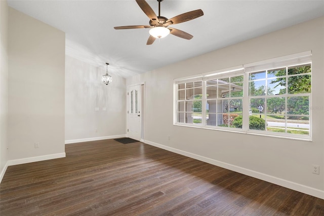 6095 W Douneray Loop, Crystal River, FL 34429 - unfurnished room with baseboards, lofted ceiling, dark wood-type flooring, and ceiling fan with notable chandelier